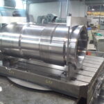 Industrial machinery component displayed on a precision machining table, relevant to Eric Walper's expertise in IT solutions for technical projects.
