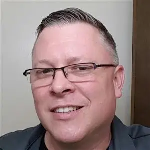 Eric Walper smiling in a professional setting, showcasing his expertise in IT services and solutions for Clear Sailing IT Services.